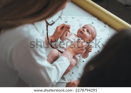 Doctor hands use stethoscope to check newborn baby health and take care him or cure the disease or disorder. Close up of pediatrician hand using a stethoscope to listen and checking heartbeat.