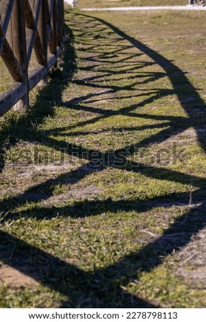 Shadow of a wooden fence in perspective 