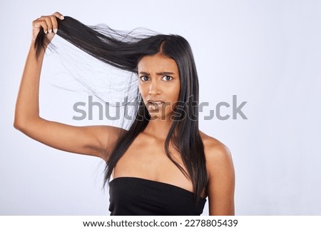 Hair damage, breakage and portrait of a frustrated woman isolated on a white background in studio. Bad, unhappy and an Indian girl sad about split ends, tangled hairstyle and frizzy haircare Royalty-Free Stock Photo #2278805439