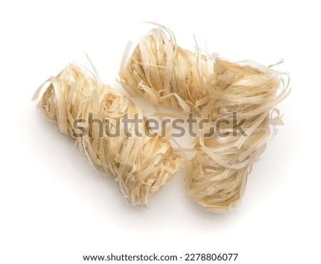 Top view of three wooden kindling rolls isolated on white