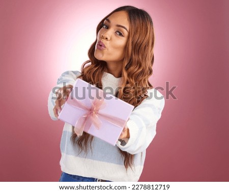Portrait, gift and valentines day with a woman in studio on a pink background holding a box for celebration. Party, birthday and present with a happy young female giving while celebrating an event