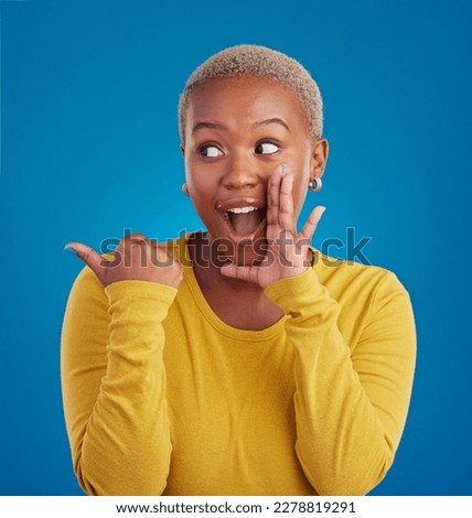 Black woman, gossip and secret in studio with hand on face for sale announcement. African female model on a blue background to whisper message, news information or wow rumor pointing at mockup deal Royalty-Free Stock Photo #2278819291