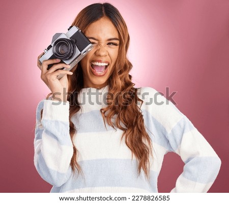 Camera, photography and happy woman in studio for fun, posing and gen z retro aesthetic on pink background. Lens, photographer and girl posing for picture, photo or photograph on isolated mockup