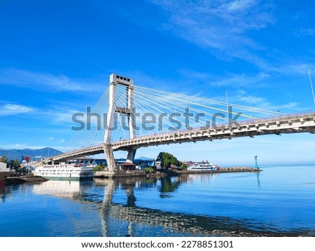 Manado, Indonesia – March 19, 2023: Soekarno bridge is one of icon at the Manado City, North Sulawesi. This brigde have leght about 1127 meter.  The view of Soekarno bridge with beautiful Royalty-Free Stock Photo #2278851301