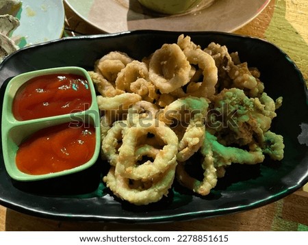 Cumi goreng tepung or fried squid. Cut the squid into pieces, aplied with flour and then deep fried. Photo taken in Bali - Indonesia. March 2023