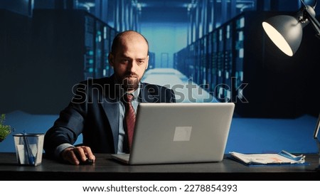 System administrator working in data center render farm, creating cloud computing service for innovation and digitalization. Database admin using big hardware data in server room. Royalty-Free Stock Photo #2278854393
