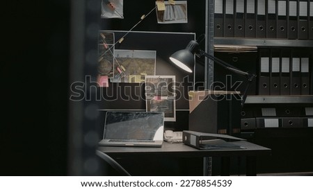 Detective board with clues over desk in police archive, crime scene photos connected on wall and case files in investigation office. Empty incident room with forensic evidence and surveillance. Royalty-Free Stock Photo #2278854539