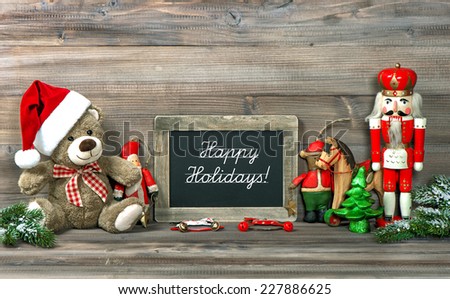 christmas decoration with antique toys and blackboard and sample text Happy Holidays! retro style toned picture