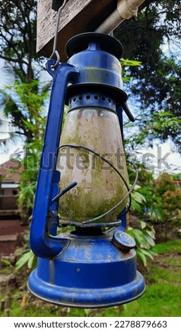 Classic retro lantern or vintage old lantern or kerosene lamp hanging on a wooden pole in garden