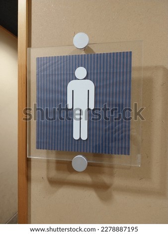 public toilet symbol on wall background