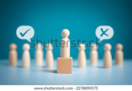 Wooden figures peg dolls stand above wooden cube among others with vote yes or no symbol. Open-mindedness or public hearing, concept of elections. Volunteers, candidates, constituency electorates.