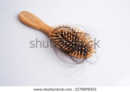 Hair loss fall with comb brush isolated on white background. Royalty-Free Stock Photo #2278898355