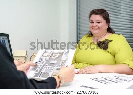 Close-up of business negotiations between a designer and a client, discussion of the interior of a house, apartment, apartment. High quality photo