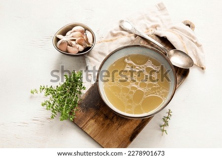Broth in Bowl on gray background, healthy food, top view, copy space Royalty-Free Stock Photo #2278901673