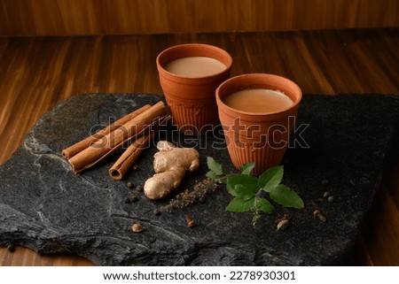 Earthen tea cup or Chai in kulhad with Ginger, Cardamom  Cinnamon tulsi Royalty-Free Stock Photo #2278930301