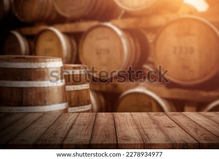 oak wood table on oak barrel background Royalty-Free Stock Photo #2278934977