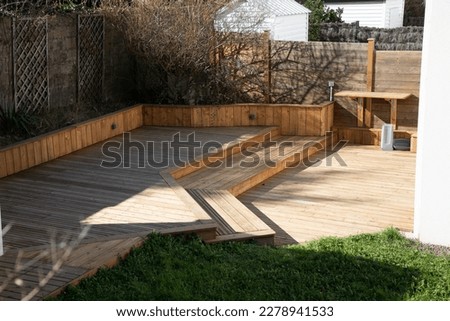 wooden terrace different levels in the garden of the house