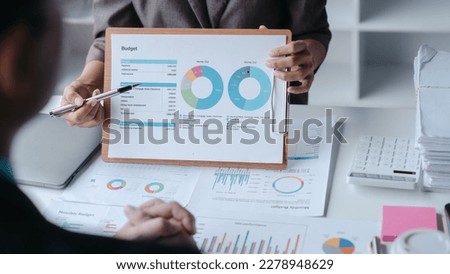 Auditor and the company's bookkeeper jointly review the balance sheet and assets, liabilities and equity information in the quarterly report, bookkeeping concept.