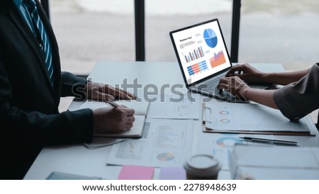Auditor and the company's bookkeeper jointly review the balance sheet and assets, liabilities and equity information in the quarterly report, bookkeeping concept.