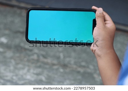 Photo of a blank screen cellphone in hand