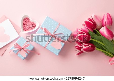 Mother's Day concept. Top view photo of blue gift boxes with ribbon bows bouquet of pink tulips heart shaped saucer with sprinkles and envelope with postcard on isolated pastel pink background