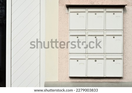 View of white mailboxes on building wall Royalty-Free Stock Photo #2279003833