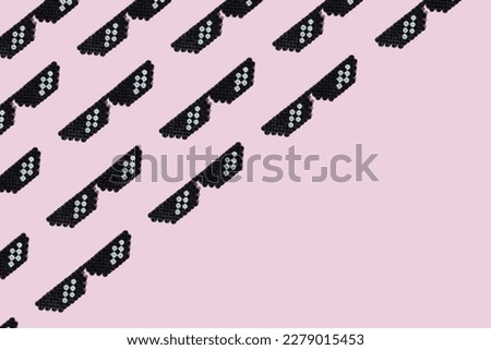 Pattern made of pixel glasses on bright pink background. Creative retro concept. Flat lay.