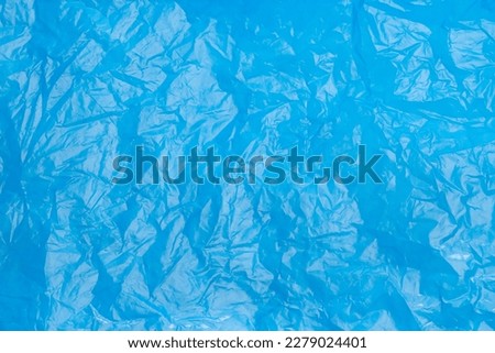 Crumpled light blue plastic bag as background, top view Royalty-Free Stock Photo #2279024401
