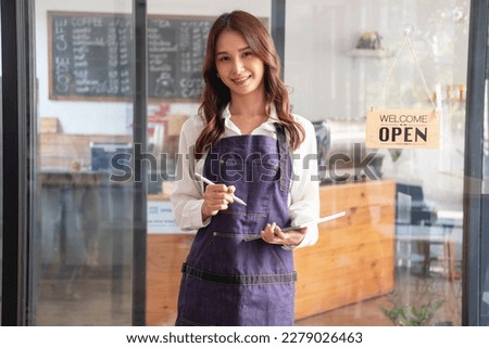 Portrait of a woman, a coffee shop business owner smiling beautifully and opening a coffee shop that is her own business, Small business concept.	