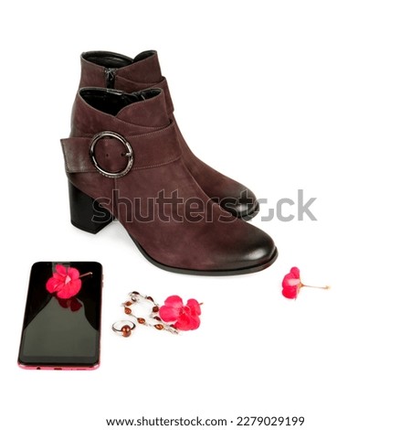Ladies ankle boots, mobile phone and jewelry isolated on white background. Free space for text.