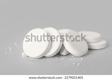 White soluble tablets on grey background