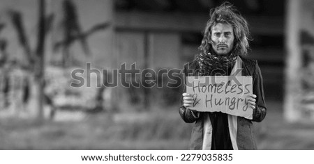 Black and white portrait of poor homeless man outdoors