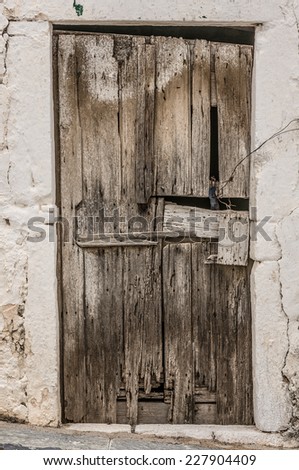 Old timber door in the scuffed wall rural scenery