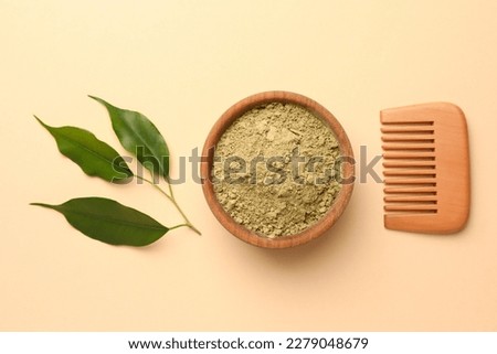 Henna powder, green leaves and comb on beige background, flat lay. Natural hair coloring