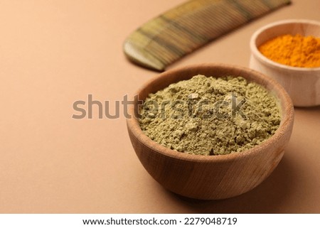 Henna and turmeric powder on beige background, closeup with space for text. Natural hair coloring