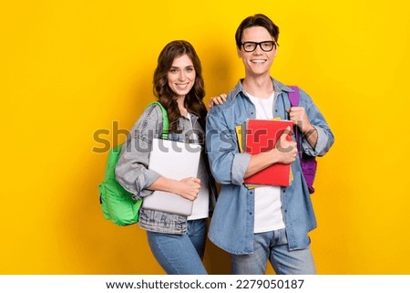 Photo of attractive funny best friends dressed denim starting college education isolated yellow color background