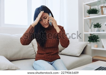 Woman talking on phone angry and sad at home, fight over phone