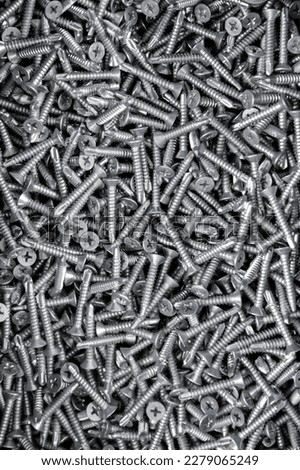 tapping screws made od steel, metal screw, iron screw, chrome screw, screws as a background, wood screw, Royalty-Free Stock Photo #2279065249