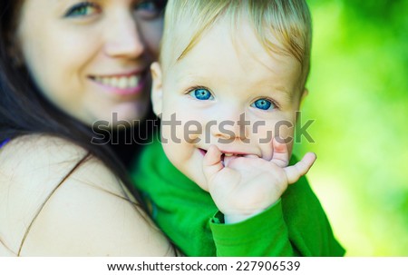 Happy mother and son laughing together outdoors