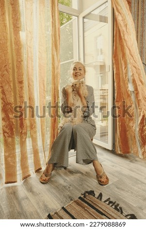 Happy fresh mature middle aged woman stretching in bed waking up alone happy concept, smiling old senior lady awake after healthy sleep sitting in cozy comfortable bedroom interior enjoy good morning