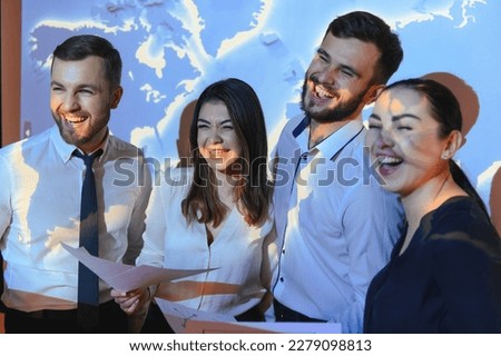 Image of businesspeople standing against world map background.