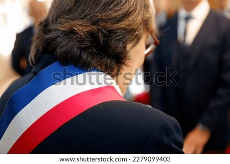View of the tricolor scarf flag of mayor during wedding celebration.    France.  Royalty-Free Stock Photo #2279099403