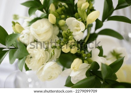 Bouquet of white freesias. Decoration on the occasion of First Holy Communion. Flowers in the church for the first holy communion.