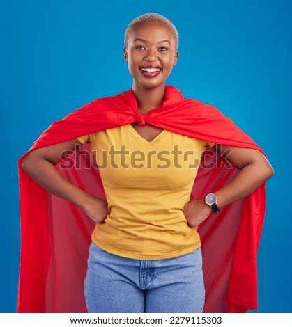Black woman, superhero cape and portrait in studio, blue background and fashion. Happy female model, superwoman and brave cosplay character of justice, smile and pride of girl power, proud and strong Royalty-Free Stock Photo #2279115303