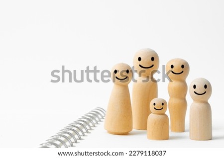 Happy face on wooden figures of family members. Emotion and satisfaction family concepts.