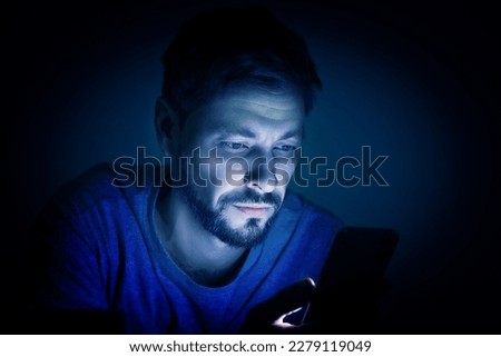 Internet addiction. Man using smartphone at night. Toned in blue Royalty-Free Stock Photo #2279119049