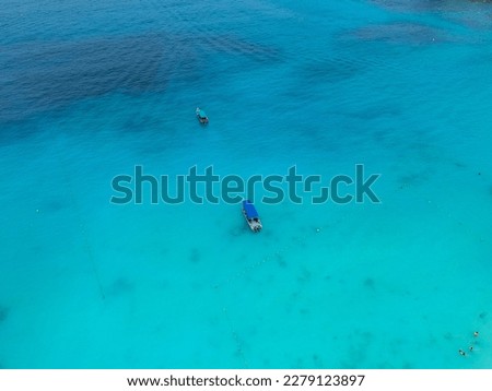 Aerial top blue view with boat in beautiful and amazing blue Redang Island, Terengganu, Malaysia.