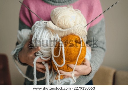 Woman hands holding balls of colored balls of thread. Knitting. knit, needle, yarn. Hobby needlework. Domestic lifestyle. Fashion portrait. Freelance concept. Royalty-Free Stock Photo #2279130553