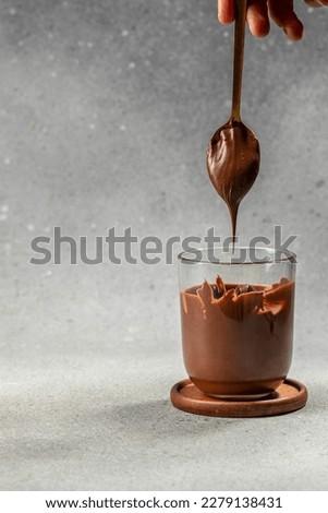 Spoon with tasty chocolate cream. Hazelnut spread with nuts and chocolate. place for text, top view. Royalty-Free Stock Photo #2279138431
