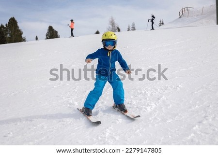 Happy family, enjoying ski holiday with children, sunny beautiful weather outdoors